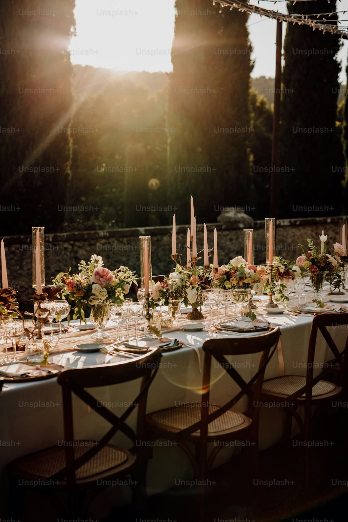 A long wedding table dressed with flowers and candles